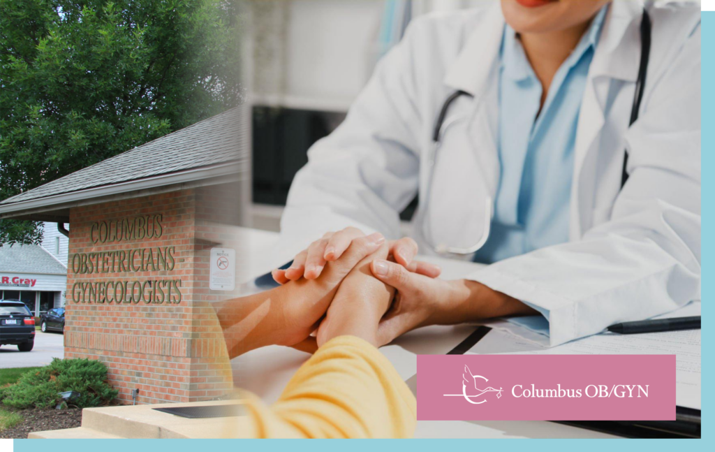 OB-GYN doctor holding a patient’s hand during a compassionate consultation, with Columbus OBGYN building and branding visible.
