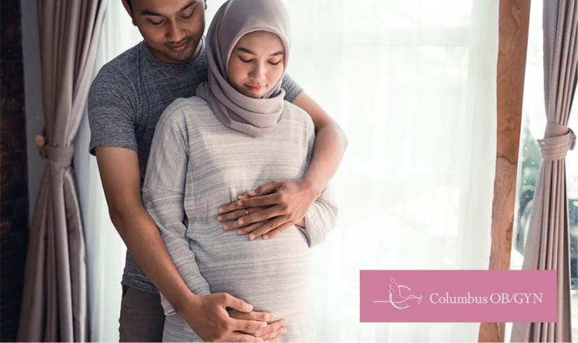 Man hugging pregnant partner
