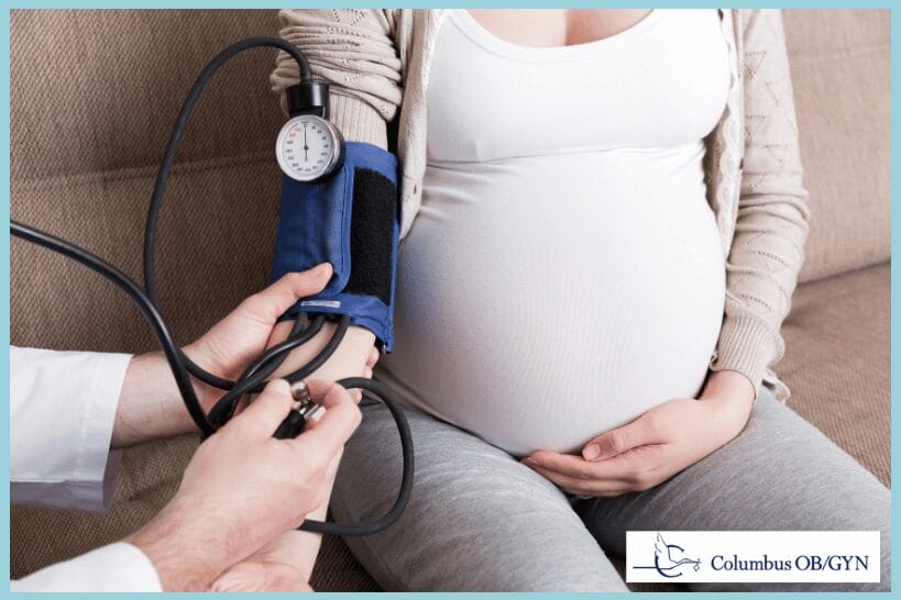 Pregnant woman having blood pressure checked during high risk care.